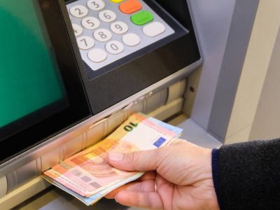 Vannes, France, January 7, 2022: Withdrawing euro banknotes from a cash machine