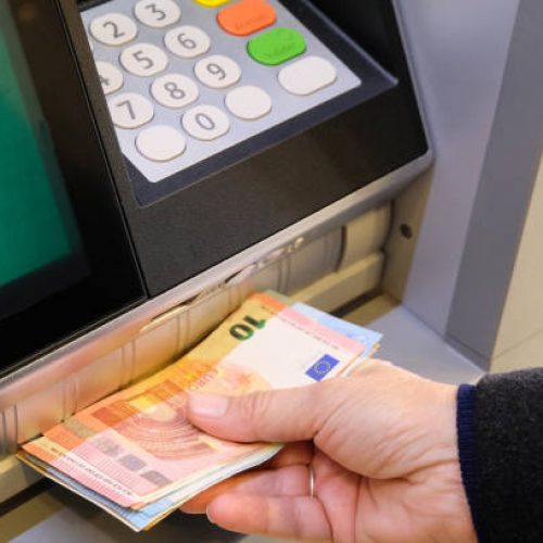 Vannes, France, January 7, 2022: Withdrawing euro banknotes from a cash machine